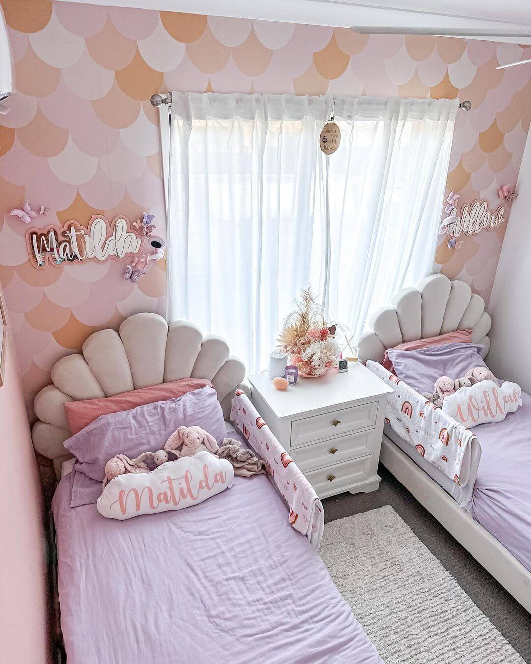 Whimsical kids room design with pastel colors and shell beds